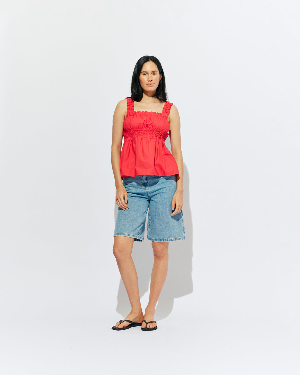 TRULLI TOP CHERRY | Sleeveless cotton top with a square neckline, designed in our cherry red organic cotton. This top falls to a full A-line shape and has shirring through the bust and straps for an accommodating fit. Make it a matching set with our...