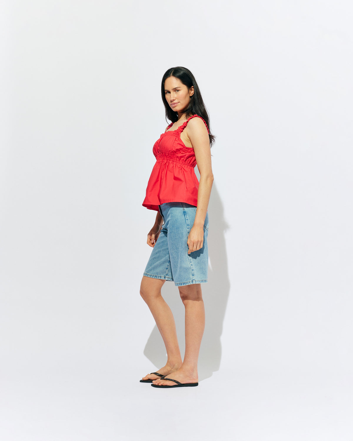 TRULLI TOP CHERRY | Sleeveless cotton top with a square neckline, designed in our cherry red organic cotton. This top falls to a full A-line shape and has shirring through the bust and straps for an accommodating fit. Make it a matching set with our...