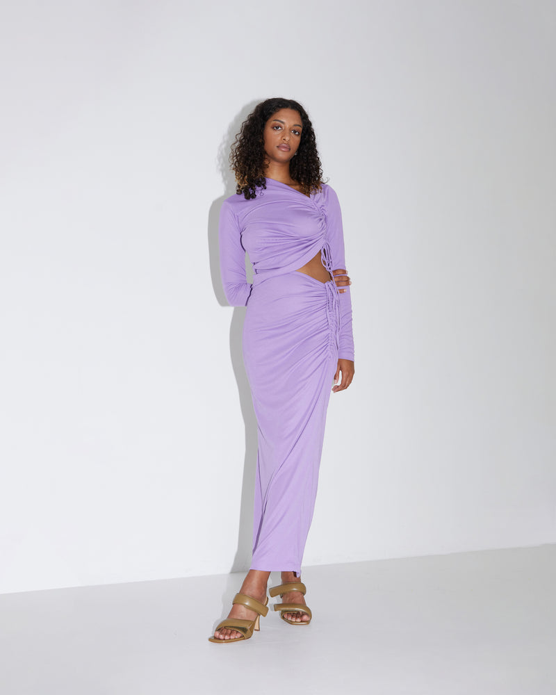 TOBY SKIRT PLUM | Knit maxi skirt with asymmetrical hems and drawstring detail at the side of the piece that creates ruching in soft folds. Cut for a close fit, the ruched detail throughout...