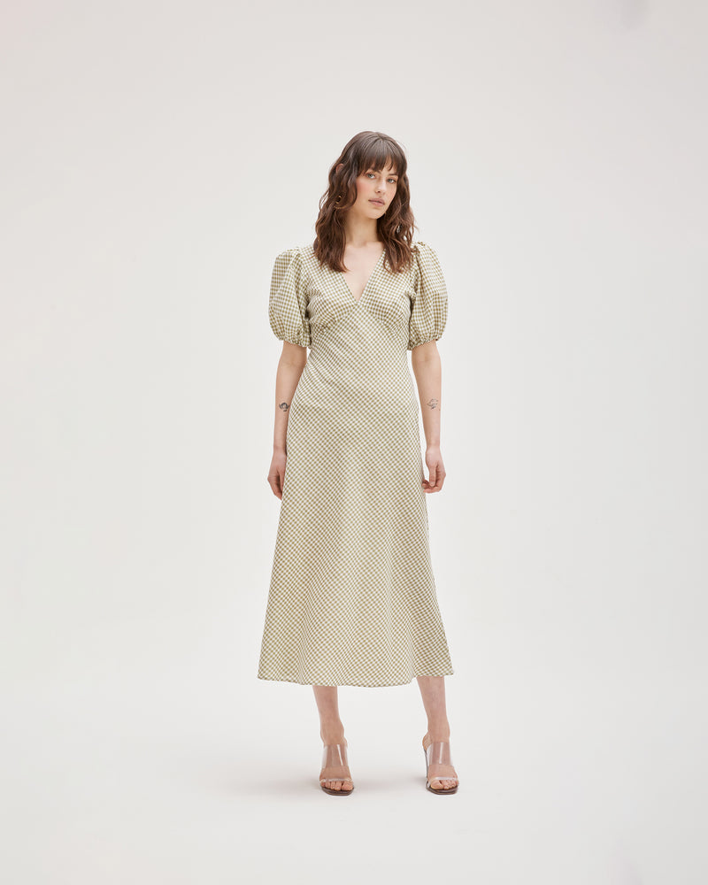 UMA DRESS KHAKI GINGHAM | Bias cut linen maxi dress with tie closure and a V-neck front and back. Cut in a khaki gingham, with elasticated puff sleeves and ruched detailing under the bust, it's...