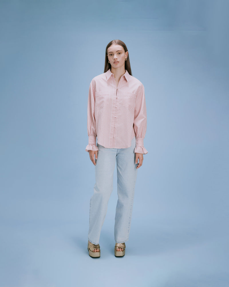 VAL GINGHAM SHIRT PINK GINGHAM | Relaxed button down shirt with frilled cuff detail and a curved back yoke, in a fresh pink gingham. The frilled cuff along with the pastel gingham adds a playful element...