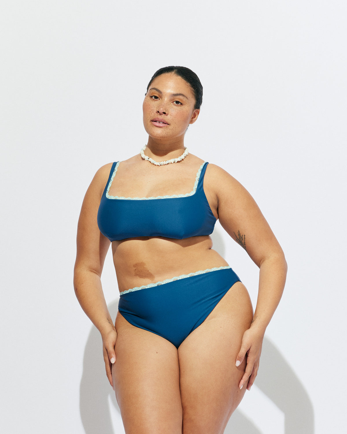 WYLIE HIGH WAIST BIKINI BOTTOM NAVY | Named after the Wylie's Baths in Sydney, these navy bikini bottoms are designed with full coverage and a high waisted cut. Featuring an aqua lace trim, make it a matching set with the Wylie Bikini Top or mix and match...