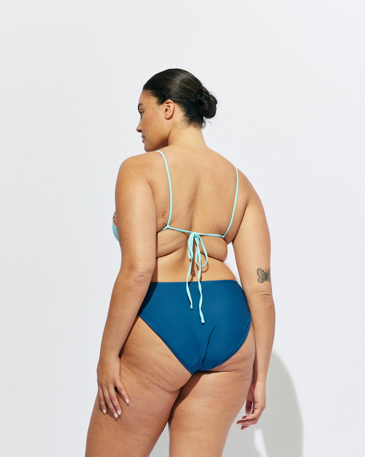 WYLIE HIGH WAIST BIKINI BOTTOM NAVY | Navy bikini bottoms, with full coverage and a high waisted cut. Featuring an aqua lace trim, make it a matching set with the Wylie Bikini Top or mix and match with our swim range.