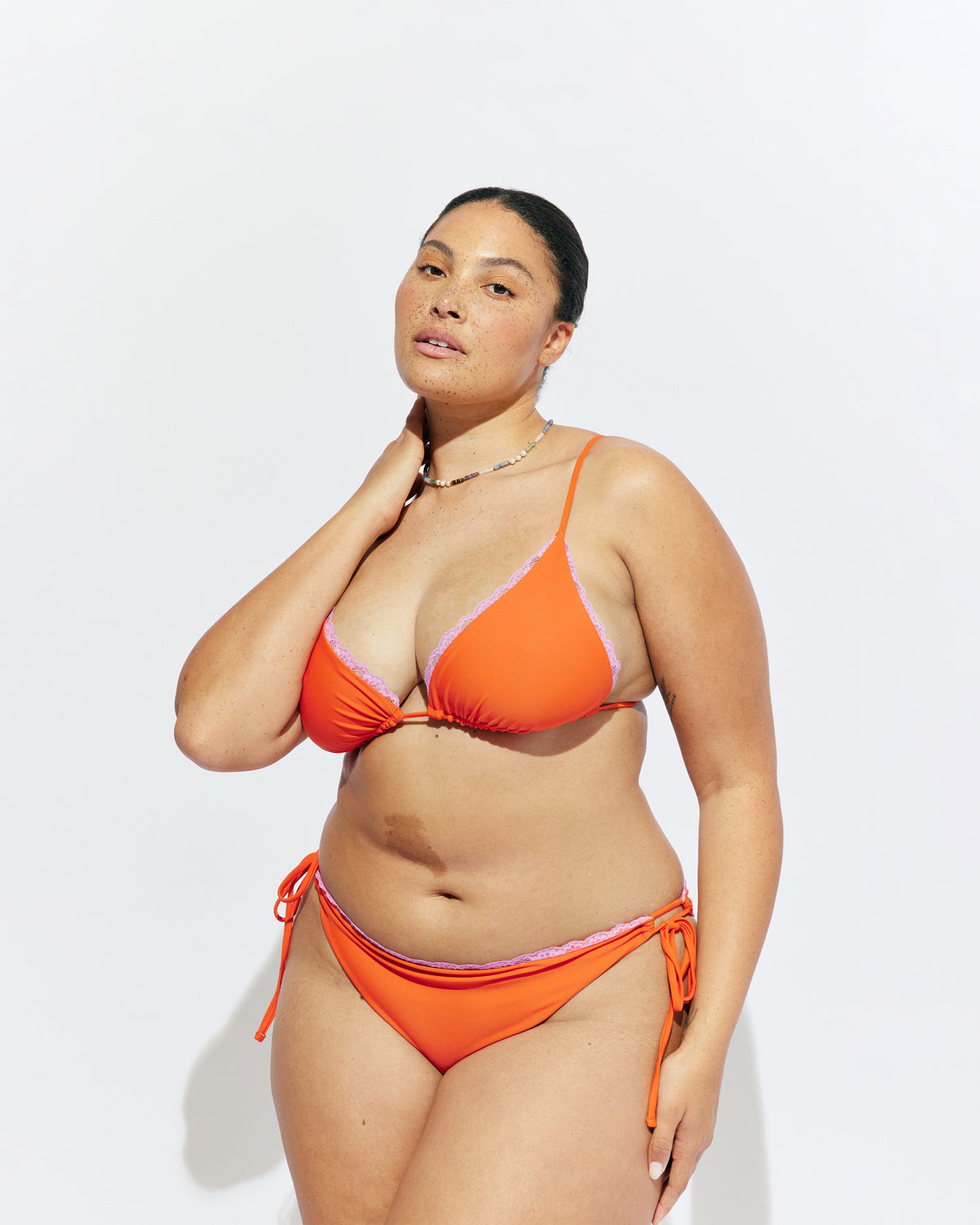 WYLIE TIE-SIDE BIKINI BOTTOM VERMILLION | Vermillion bikini bottoms, with a cheeky cut and adjustable side ties. Featuring a bright pink contrast lace trim, make it a matching set with the Wylie Triangle Bikini Top or mix and match with our swim range.