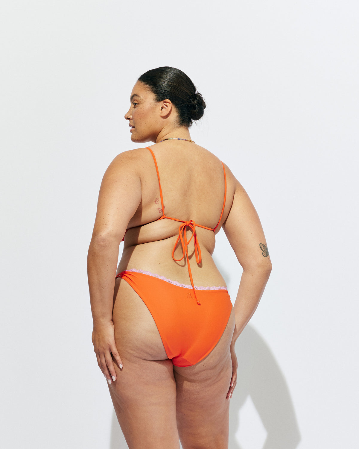 WYLIE TRIANGLE BIKINI TOP VERMILLION | Named after the Wylie's Baths in Sydney, this vermillion bikini top is designed in a classic triangle style with a vibrant pink lace trim. With adjustable ties for a flexible fit, make it a set with the Wylie Tie-side Bikini...