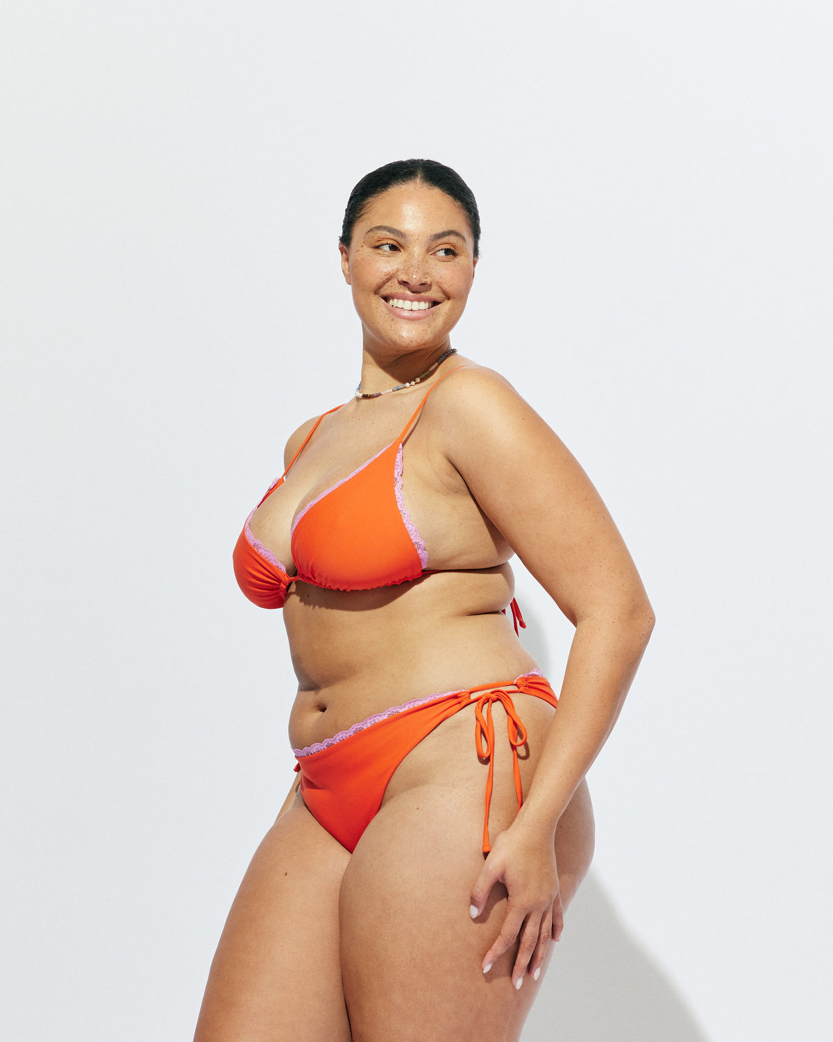 WYLIE TIE-SIDE BIKINI BOTTOM VERMILLION | Vermillion bikini bottoms, with a cheeky cut and adjustable side ties. Featuring a bright pink contrast lace trim, make it a matching set with the Wylie Triangle Bikini Top or mix and match with our swim range.