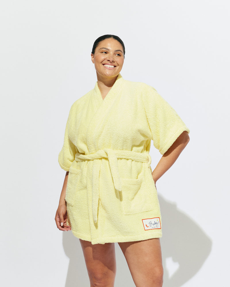 BEACH ROBE BUTTER | The ultimate poolside accessory, our very own RUBY beach robe! A mini length fit designed in a soft cotton towelling, with our diving girl patch design on the hem. 