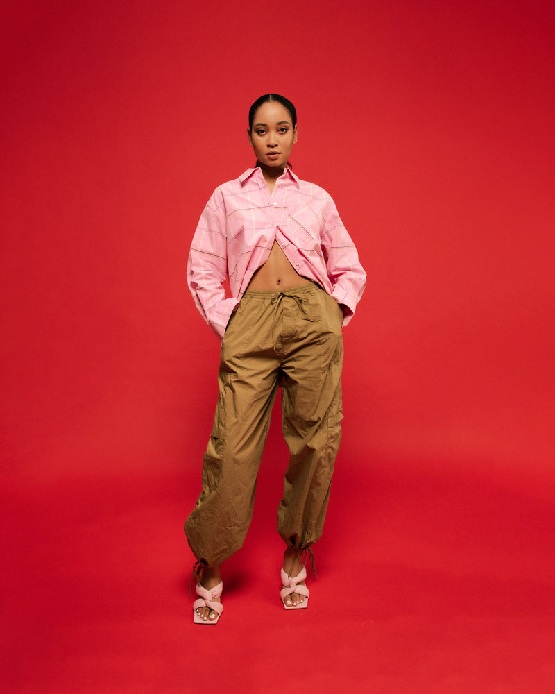 ALLORA SHIRT PINK CHECK | Oversized pink check shirt with classic shirt detailing and a large front pocket, now in an organic cotton. This piece is timeless wardrobe staple that you will wear for years...
