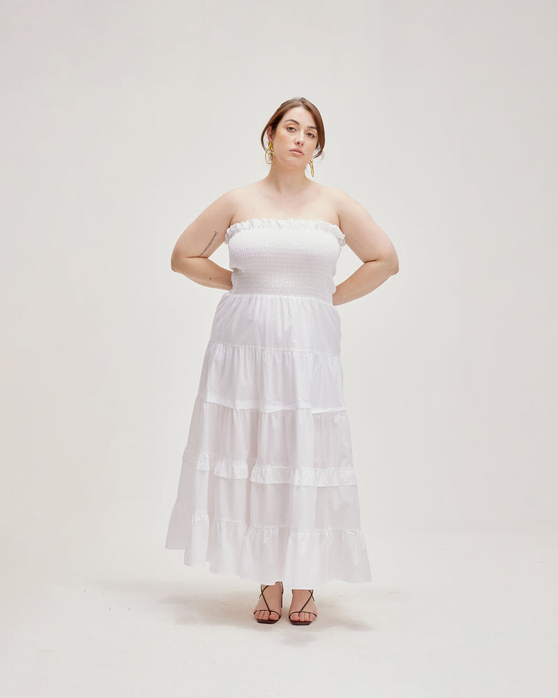 BIRD MAXI DRESS WHITE | Strapless maxi dress with a shirred bodice for a close and flexible fit, and skirt that falls in loose tiers. The contrast of the fitted bodice against the flared skirt...