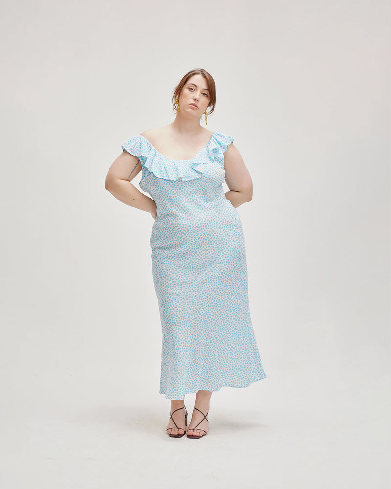 HAZEL RUFFLE DRESS DITSY FLORAL | Bias cut midi dress with a feature ruffle neckline in a ditsy blue floral print. Features a back tie and scooped back neck that adds to the soft look of...